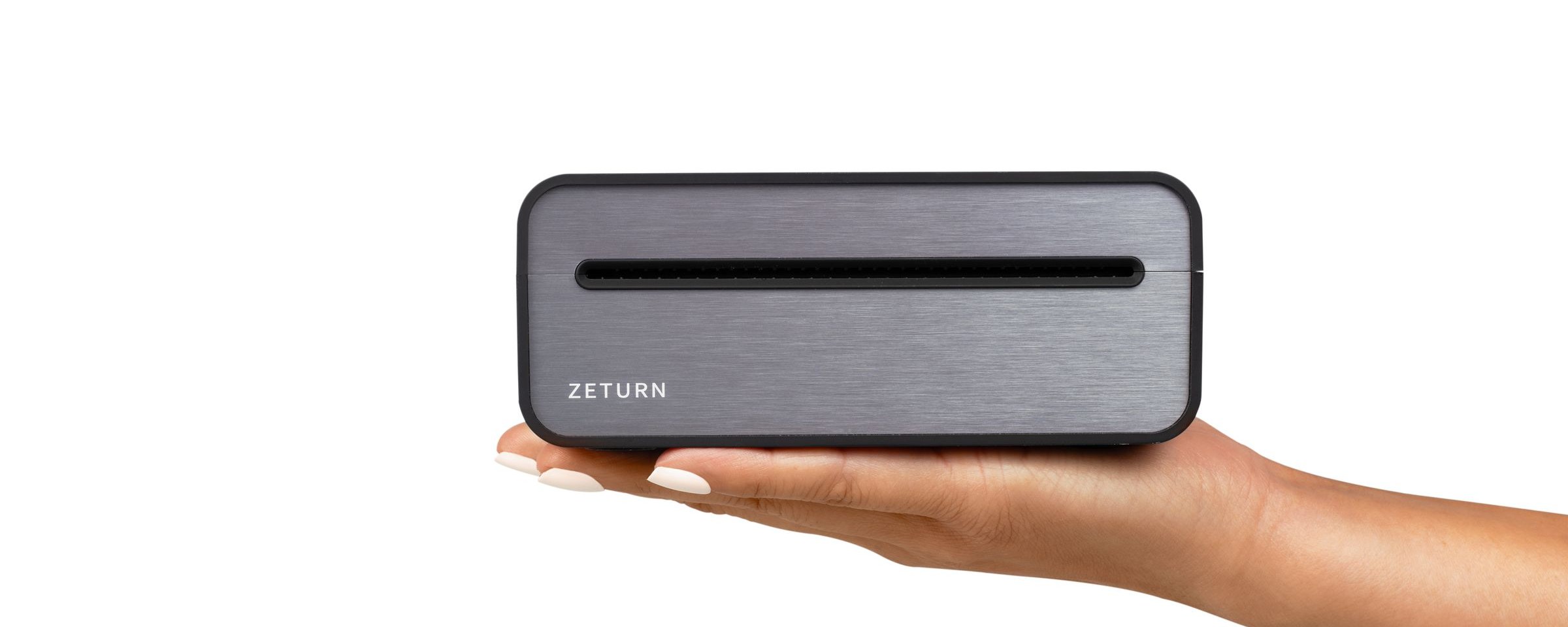 The Zeturn Tiny Printer resting on an open palm